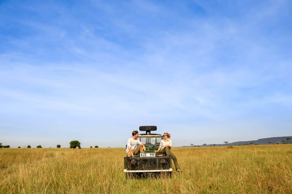 Cameron And Natasha Sit On Truck In Masai Mara
