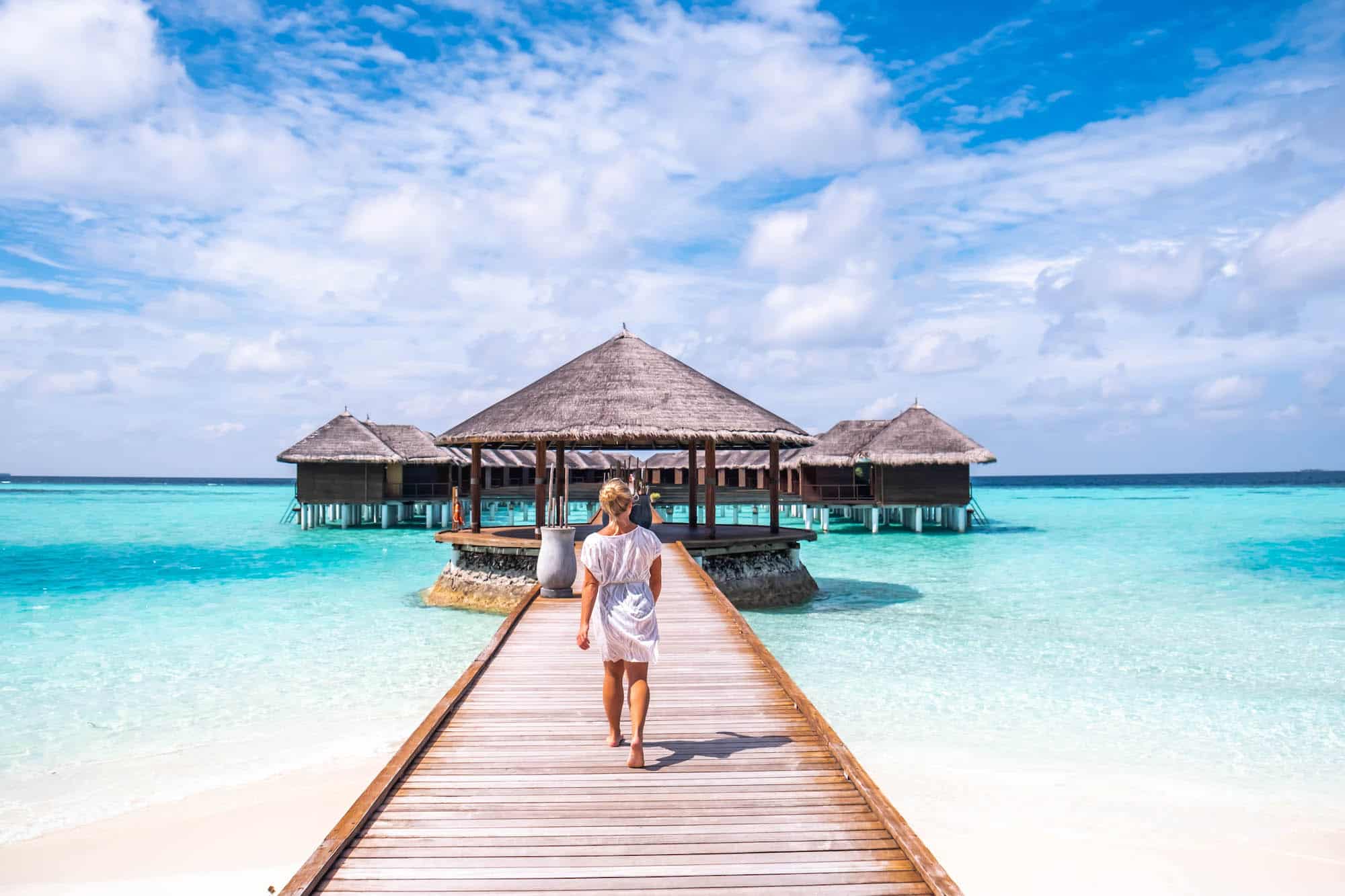 Natasha Walks Along Pier At Maafushivaru