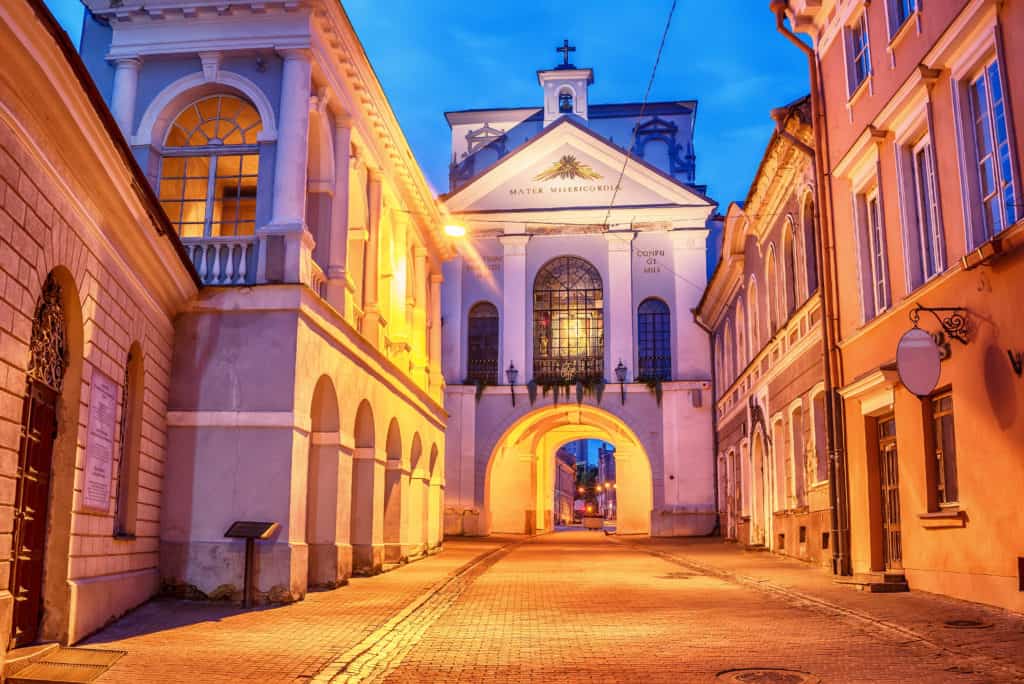 Vilnius, Lithuania: the Gate of Dawn, Lithuanian Ausros, Medininku vartai, Polish Ostra Brama, a city gate of Vilnius, one of its most important historical, cultural and religious monuments in sunrise